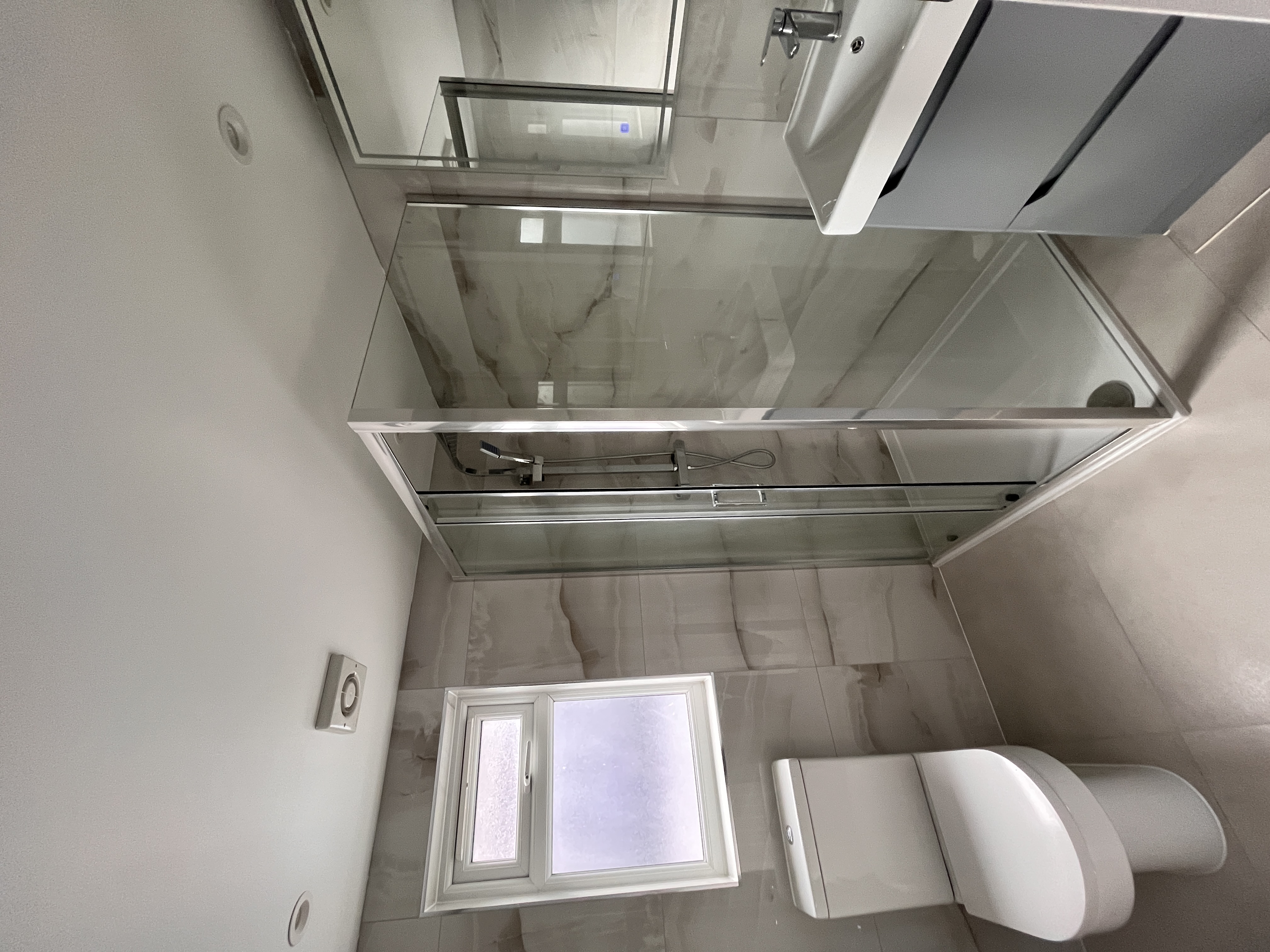 Completed modern bathroom with marble-effect tiles