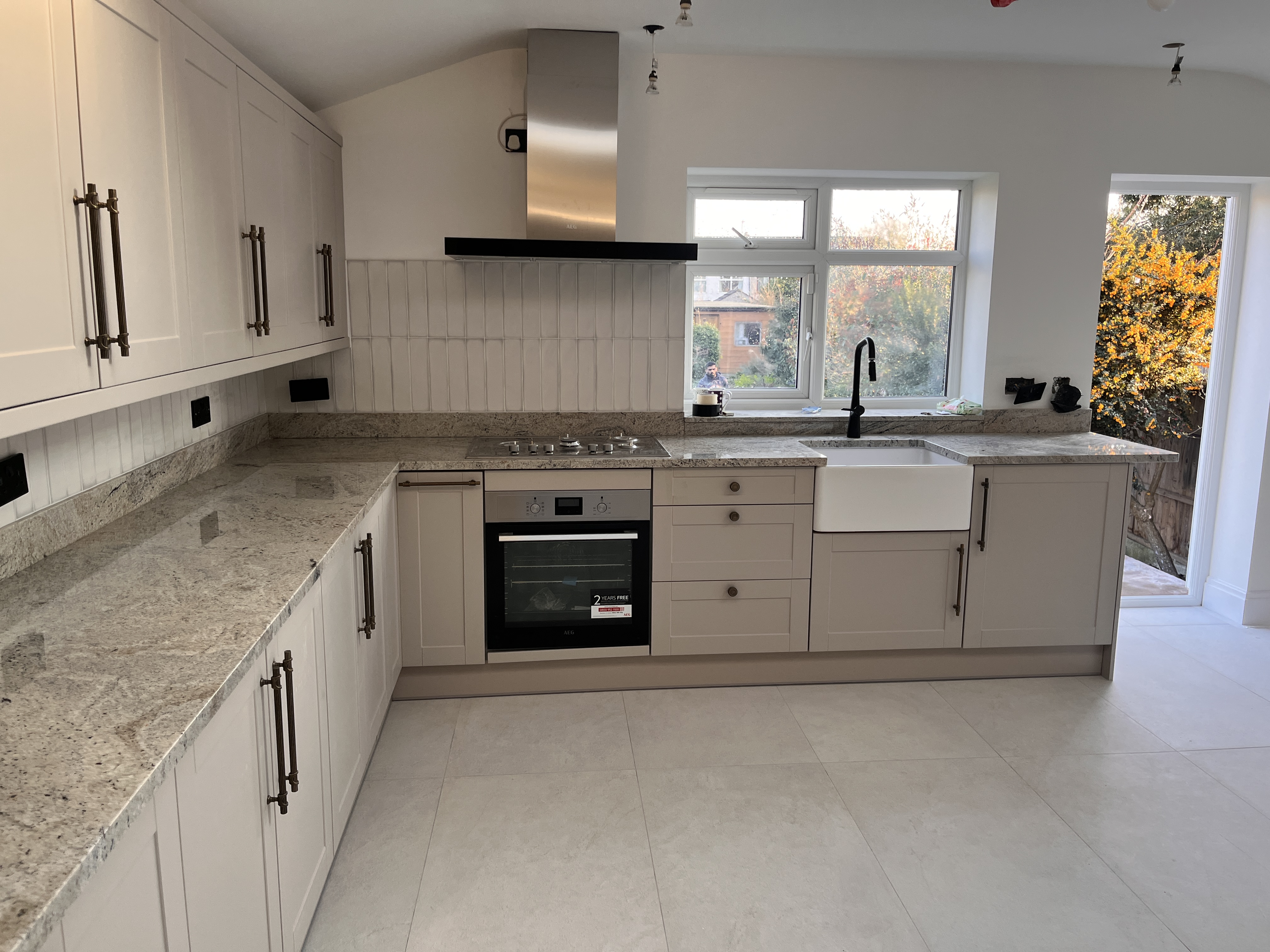 Completed shaker-style kitchen with stone worktop
